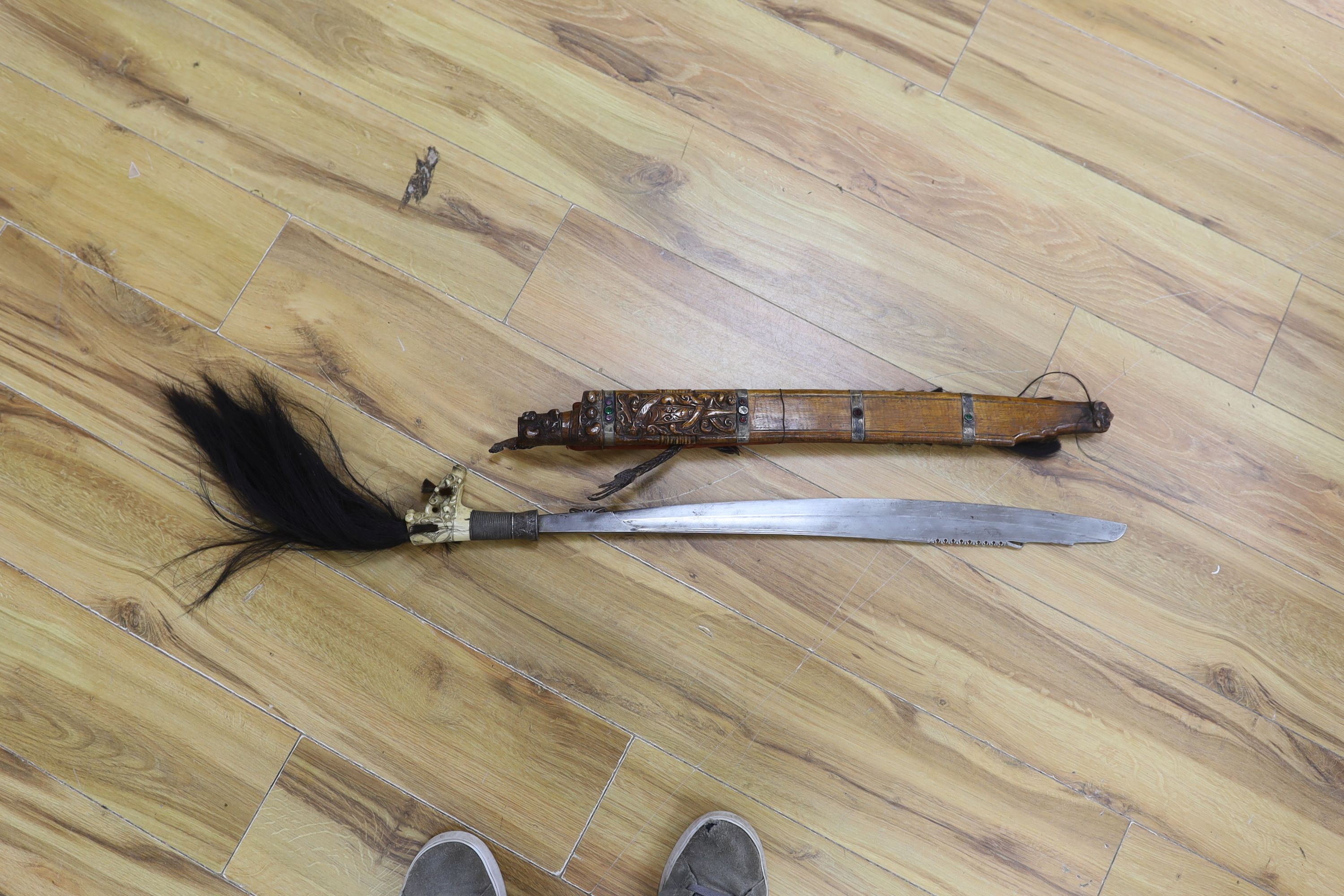 A Borneo 'headhunter's sword', a bone carving and feather swot (3), sword 77 cm long